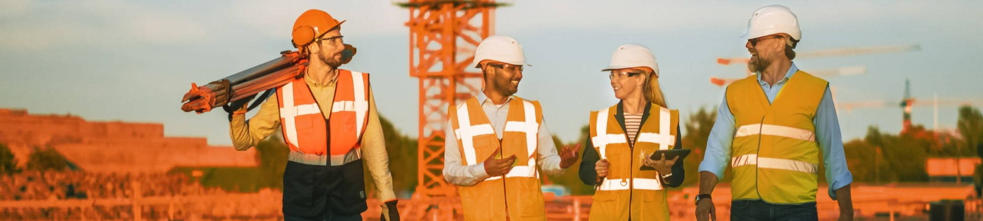 Woman consulting site workers on safety best practices